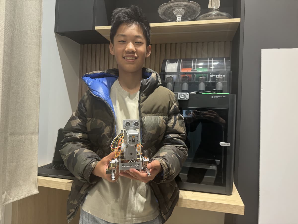 Edwin holding his Smart Dog robot